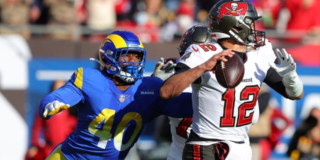 Tom Brady #12 of the Tampa Bay Buccaneers looks to throw the ball as Von Miller #40 of the Los Angeles Rams defends in the second quarter in the NFC Divisional Playoff game at Raymond James Stadium on Jan. 23, 2022, in Tampa, Florida. 