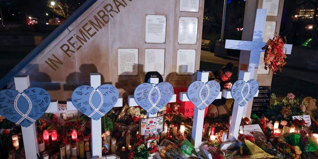 Amy Mack lights candles at a memorial at Veterans Park for the victims of a deadly Christmas parade crash in Waukesha, Wis., on Nov. 23, 2021 (AP Photo/Jeffrey Phelps, File)