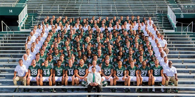 Xavier DeGroat with the Michigan State University football team in 2017 along with Coach Mark Dantonio. Photo courtesy of Matthew Mitchell.