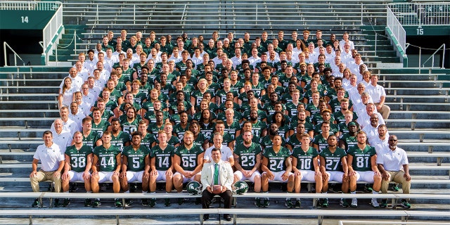 Xavier DeGroat with the Michigan State University football team in 2017 along with Coach Mark Dantonio. Photo courtesy of Matthew Mitchell.