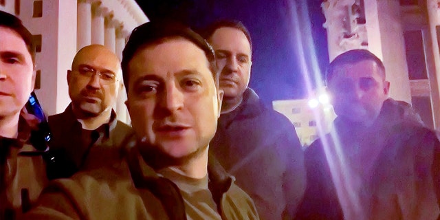 Ukrainian President Volodymyr Zelenskyy stands alongside other government officials in a video posted to social media Friday, Feb. 25, 2022, vowing to defend the country from a Russian invasion. 
