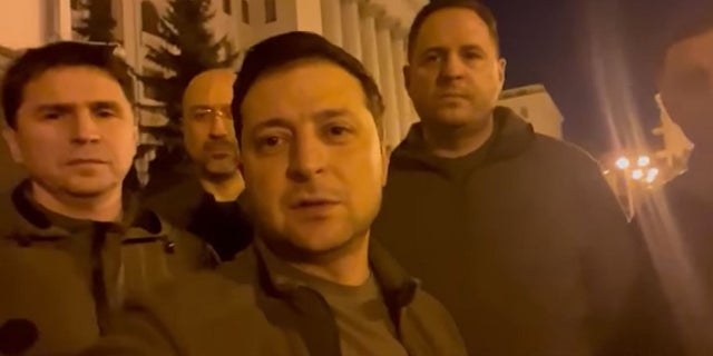 Ukrainian President Volodymyr Zelenskyy stands alongside other government officials in a video posted to social media Friday vowing to defend the country from a Russian invasion.
