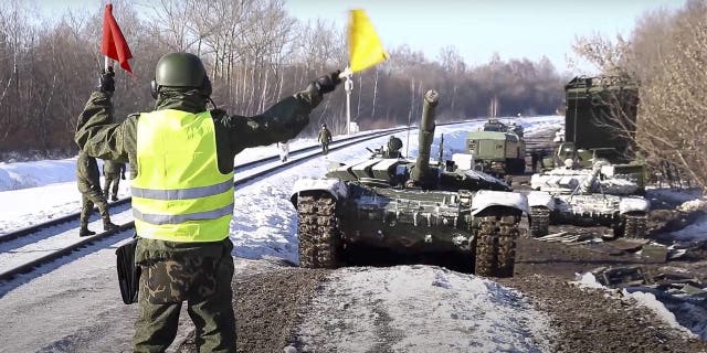 In this photo taken from video provided by the Russian Defense Ministry Press Service on Wednesday, Feb. 16, 2022, Russian army tanks are loaded onto railway platforms to move back to their permanent base after drills in Russia.