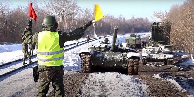In this photo taken from video provided by the Russian Defense Ministry Press Service on Wednesday, Feb. 16, 2022, Russian army tanks are loaded onto railway platforms to move back to their permanent base after drills in Russia.