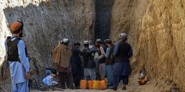 Rescuers try to reach and rescue a  boy trapped for two days down a well in a remote southern Afghan village of Shokak, in Zabul province. (Photo by JAVED TANVEER/AFP via Getty Images)