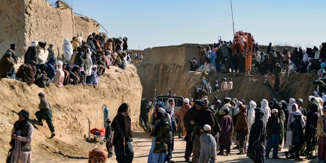 Afghan people gather as  rescuers try to reach and rescue a boy trapped for two days down a well in a remote southern Afghan village of Shokak. (Photo by Javed TANVEER / AFP) (Photo by JAVED TANVEER/AFP via Getty Images)