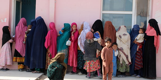 I bambini dell'Afghanistan sono visti con le loro madri il 16 gennaio 2022 a Kabul, in Afghanistan.  In Afghanistan i bambini non riescono a stare in piedi nonostante la loro età;  Il motivo è la fame.  (Photo by Syed Kothaiberti Sadat / Anatolia Agency via Getty Images)