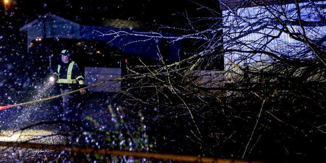 Emergency personnel survey a damaged mobile home after a possible tornado passed through, Thursday, Feb. 17, 2022, in Leeds, Ala. (AP Photo/Butch Dill)