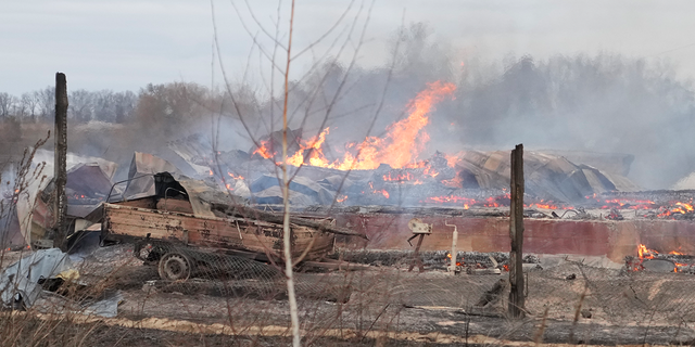 Flame and smoke rise from the debris of a privet house in the aftermath of Russian shelling outside Kyiv, Ukraine, Thursday, Feb. 24, 2022. Russia on Thursday unleashed a barrage of air and missile strikes on Ukrainian facilities across the country.