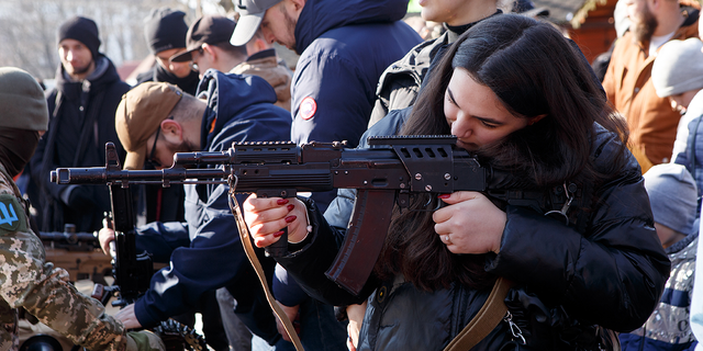 A participant of an open civil defence exercise aims at a target, Uzhhorod, western Ukraine 