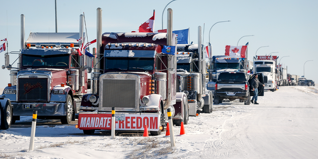 A truck convoy of anti-COVID-19 vaccine mandate demonstrators continue to block the highway at the busy U.S. border crossing in Coutts, Alta., Wednesday, Feb. 2, 2022. 