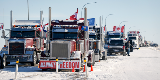 A truck convoy of anti-COVID-19 vaccine mandate demonstrators continue to block the highway at the busy U.S. border crossing in Coutts, Alberta, Wednesday, Feb. 2, 2022.