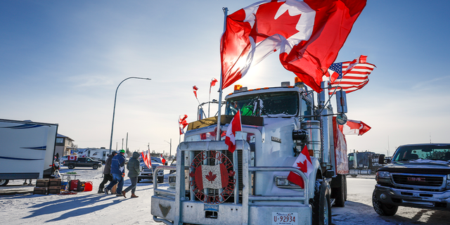 The last truck blocking the southbound lane moves after a breakthrough resolved the impasse where anti-COVID-19 vaccine mandate demonstrators blocked the highway at the busy U.S. border crossing in Coutts, Alberta, Wednesday, Feb. 2, 2022. 