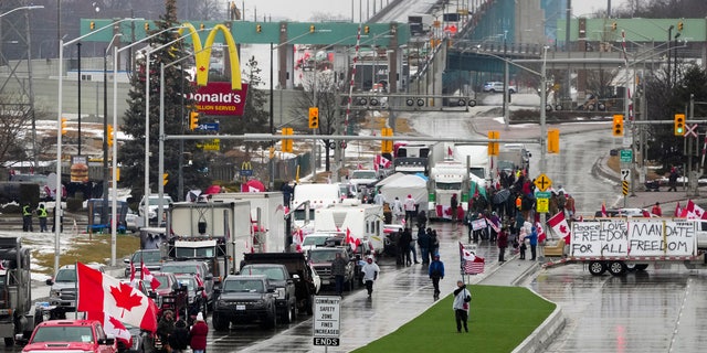 Truckers and supporters block the access leading from the Ambassador Bridge, linking Detroit and Windsor, as truckers and their supporters continue to protest against COVID-19 vaccine mandates and restrictions, in Windsor, Ontario, Friday, Feb. 11, 2022. (Associated Press)