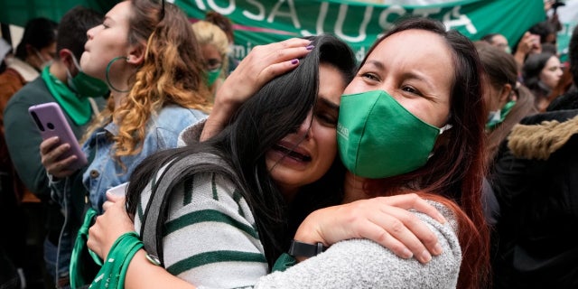 Abortion-rights activists celebrate after the Constitutional Court approved the decriminalization of abortion, lifting all limitations on the procedure until the 24th week of pregnancy, in Bogota, Colombia, Monday, Feb. 21, 2022.
