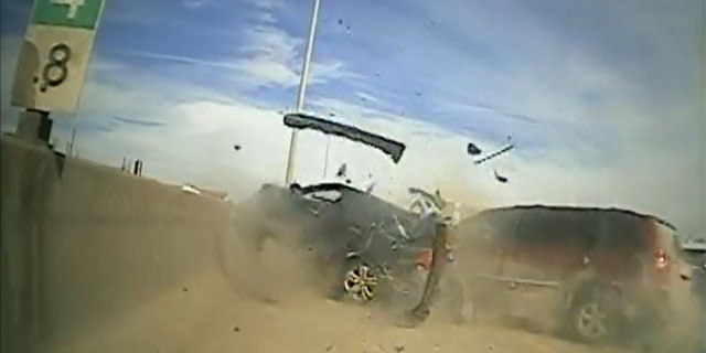 Moments after a trooper left the driver's side of the stopped vehicle, a red minivan rear-ends the car.