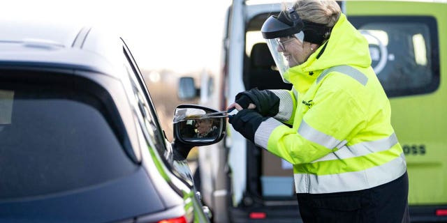 A member of staff collects a COVID-19 PCR test, at the COVID testing site of Svagertorp, Malmoe, Sweden, Tuesday, Feb. 8, 2022. 