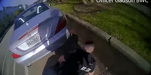 Bodycam footage released Wednesday by the Houston Police Department captured a shootout in which three officers were allegedly wounded by a carjacking suspect. In this image, a wounded officer is seen on the ground.