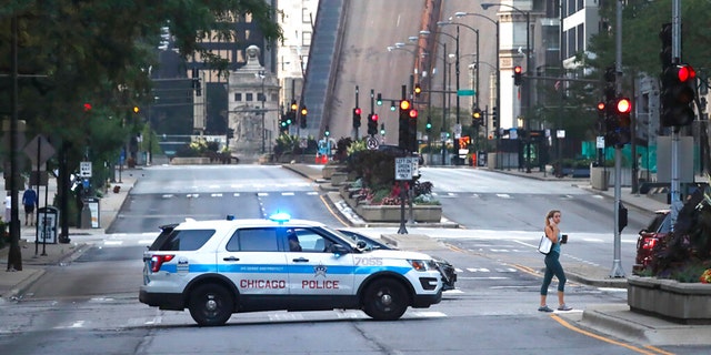 Michigan Avenue in Chicago is seen with a city police vehicle in the foreground, Aug.  10, 2020.