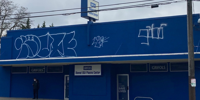 Graffiti mars the front of this Biomat USA Plasma Center in the Crown Hill neighborhood of Seattle, Washington, in Feb. 2022.