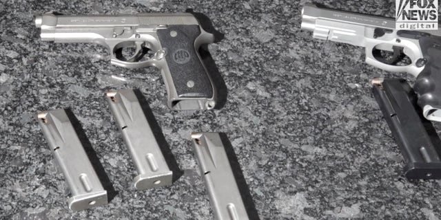 Handguns displayed on a counter.