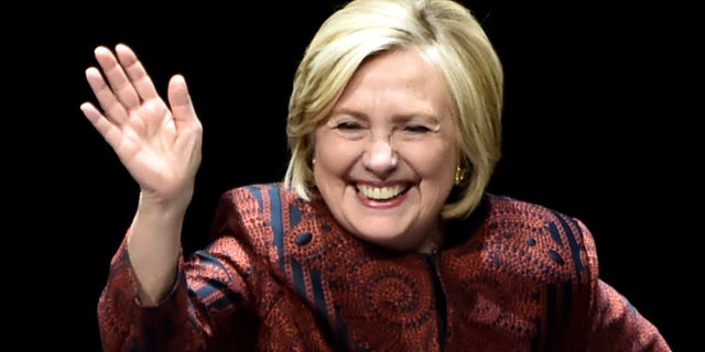 Hillary Clinton waves.