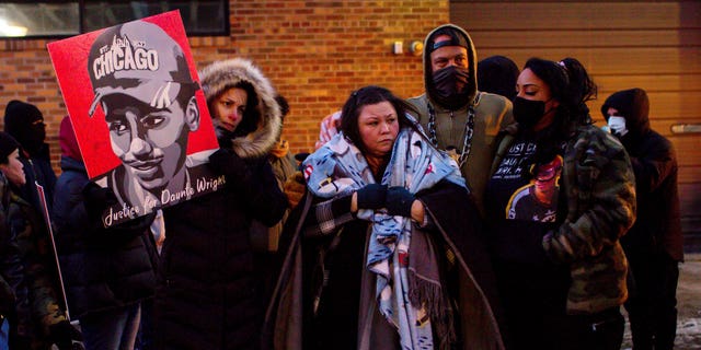 Katie Bryant, Daunte Wright's mother, is surrounded by community members and activists at the apartment building where activists say Hennepin County Judge Regina Chu lives after former officer Kim Potter was sentenced to two years in prison Friday, Feb. 18, 2022, in Minneapolis. 
