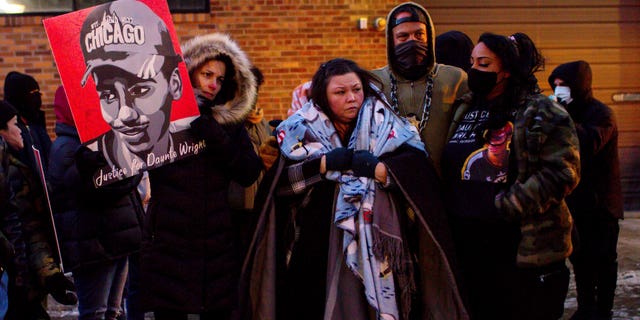 Katie Bryant, Daunte Wright's mother, is surrounded by community members and activists at the apartment building where activists say Hennepin County Judge Regina Chu lives after former officer Kim Potter was sentenced to two years in prison Friday, Feb. 18, 2022, in Minneapolis.