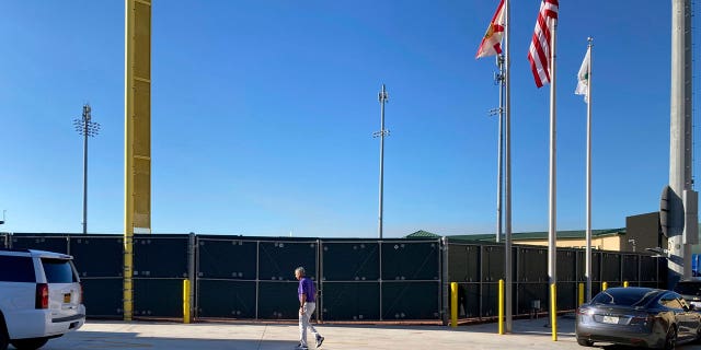 Major League Baseball Commissioner Rob Manfred walks at Roger Dean Stadium in Jupiter, Florida, Friday, Feb. 25, 2022, during MLB labor negotiations.