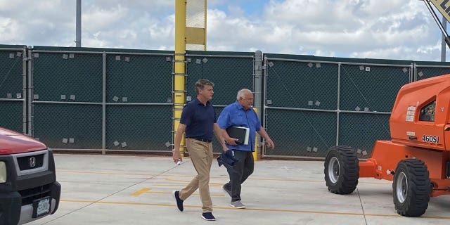 New York Yankees managing general partner Hal Steinbrenner, left, and San Diego Padres vice chairman Ron Fowler walk at Roger Dean Stadium in Jupiter, Florida, where baseball labor talks continue Thursday, Feb. 24, 2022.