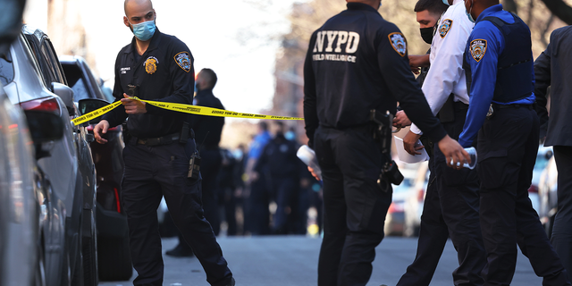 NYPD officers respond to the scene of a shooting that left multiple people injured in the Flatbush neighborhood of the Brooklyn borough on April 06, 2021 in New York City. On Friday, a 16-year-old girl was fatally shot anf two other teenagers were injured, police say as gun violence continues to plauge the city.