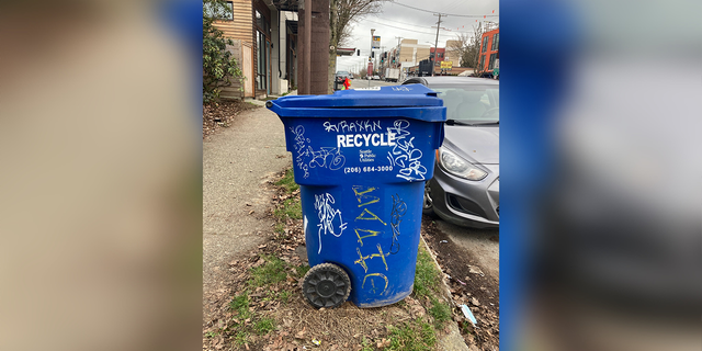 This recycling bin issued by Seattle Public Utilities bears the scars of graffiti scrawl in Seattle, Washington, in Feb. 2022.