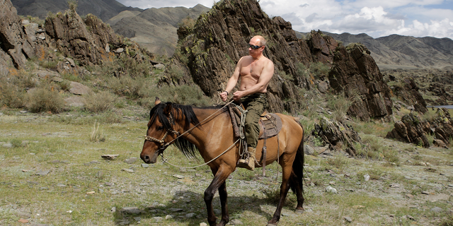 Russian President Vladimir Putin rides a horse during his vacation outside the town of Kyzyl in Southern Siberia on August 3, 2009