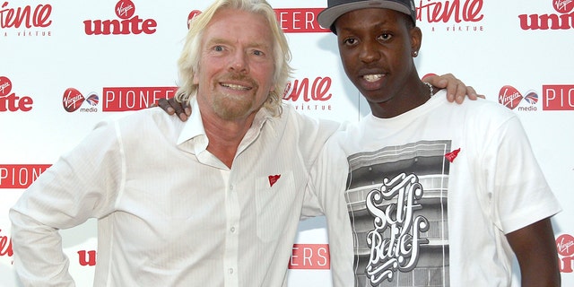FILE - Virgin boss Richard Branson and Music entrepreneur Jamal Edwards, right, pose for a photo, at the Impatience is a Virture Festival at the Royal Opera House, London, Sept. 7, 2012.