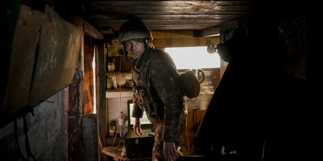 A Ukrainian serviceman stands in an observation point near the front-line village of Krymske in eastern Ukraine, Saturday, Feb. 19, 2022.