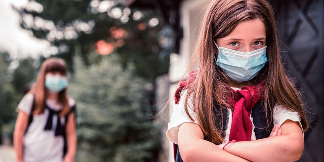 School girls wearing masks.