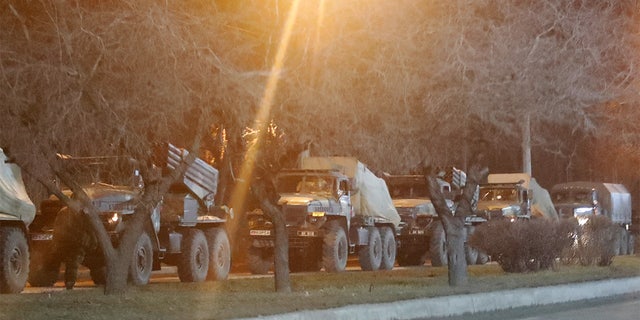 Military vehicles are seen on a street on the outskirts of the separatist-controlled city of Donetsk, Ukraine, Feb. 23, 2022.