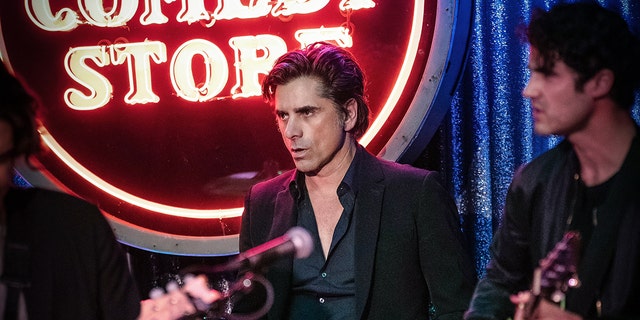 John Stamos on drums and Darren Criss on guitar for the farewell concert at Los Angeles' The Comedy Store in memory of Bob Saget.