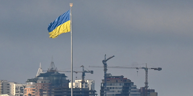 Ukraine's biggest national flag flies in Kyiv on February 26, 2022. 