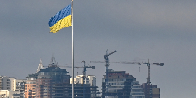 Ukraine's biggest national flag flies in Kyiv on February 26, 2022. 