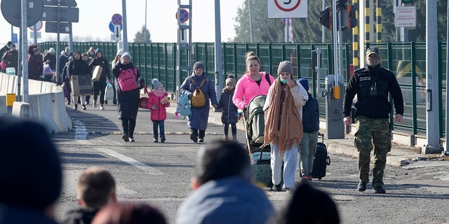 Refugees from Ukraine arrive at the Korczowa border crossing, Poland, Saturday, Feb. 26, 2022. (AP Photo/Czarek Sokolowski)