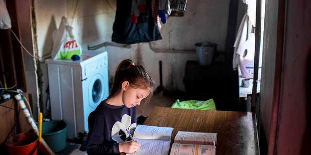 On February 13, 2022, 9-year-old Masha studies mathematics at home in eastern Ukraine.