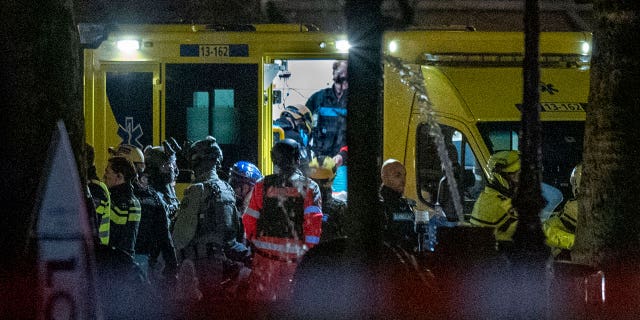 Police special intervention units and rescue workers are seen next to the Apple Store, two windows at right, in Amsterdam, Netherlands, Tuesday, Feb. 22, 2022.