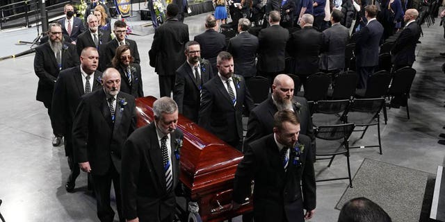 Pallbearers carry the casket of Bridgewater College campus police officer John Painter during a memorial service for Painter and campus safety officer J.J. Jefferson who were killed in the line of duty last week Wednesday Feb. 9, 2022, in Harrisonburg, Virginia. 