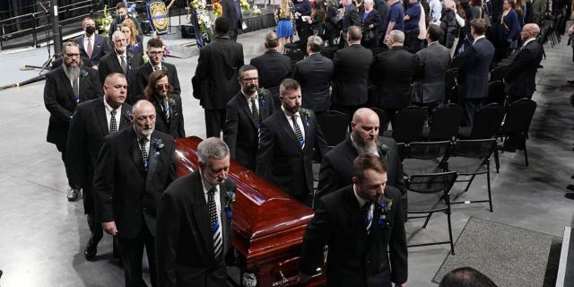 Pallbearers carry the casket of Bridgewater College campus police officer John Painter during a memorial service for Painter and campus safety officer J.J. Jefferson who were killed in the line of duty last week Wednesday Feb. 9, 2022, in Harrisonburg, Virginia.