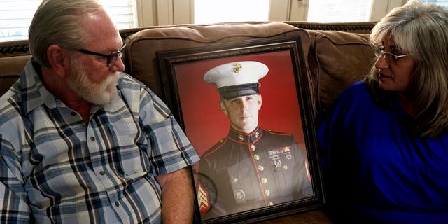 Joey and Paula Reed look at a portrait of son Trevor Reed, a Marine veteran and Russian prisoner, at their home in Fort Worth, Texas, Feb. 15, 2022. Russia is holding Trevor Reed, who was sentenced to nine years on charges he assaulted a police officer.