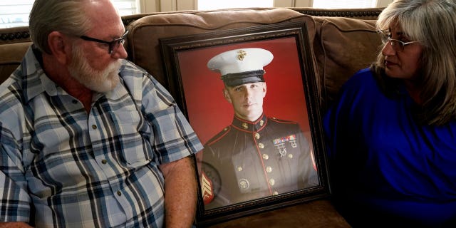 Joey and Paula Reed look at a portrait of son Trevor Reed, a Marine veteran and Russian prisoner, at their home in Fort Worth, Texas, Feb. 15, 2022. Russia is holding Trevor Reed, who was sentenced to nine years on charges he assaulted a police officer.