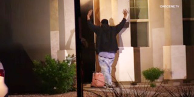 Photos from the scene show the suspect bringing out a baby during the standoff. Four officers were shot while moving to rescue the baby.