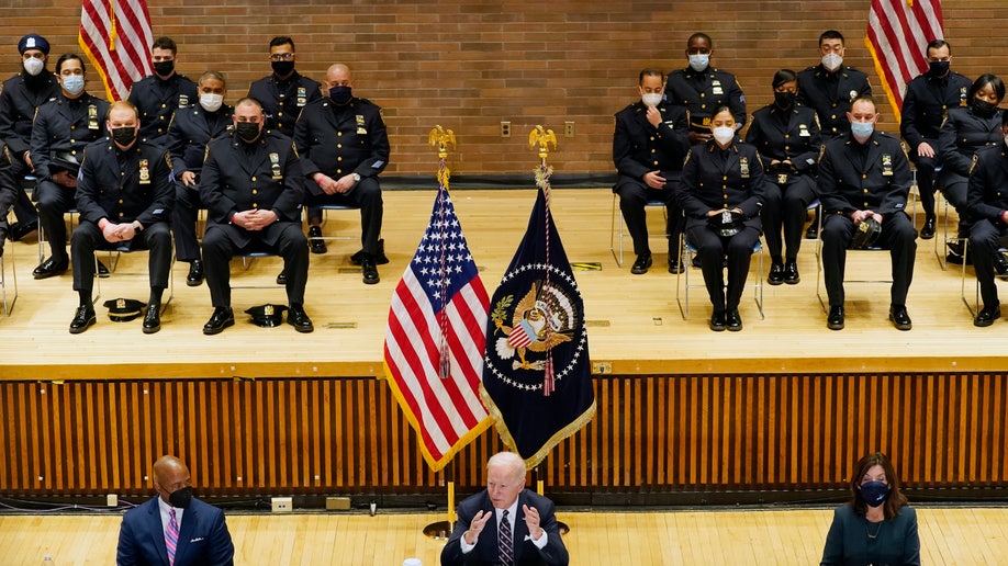 President Biden speaks at an event with New York City Mayor Eric Adams, seated left, and Gov. Kathy Hochul, D-N.Y., seated right, to discuss gun violence strategies, at police headquarters, Thursday, Feb. 3, 2022, in New York. 