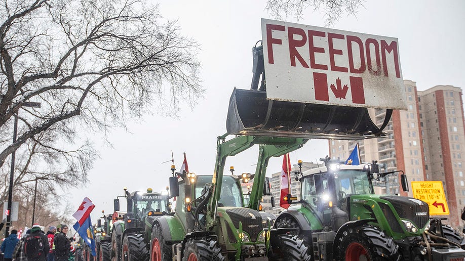 People gather in protest against COVID-19 mandates and in support of a protest against COVID-19 restrictions taking place in Ottawa, in Edmonton, Alberta, Saturday, Feb. 5, 2022. 